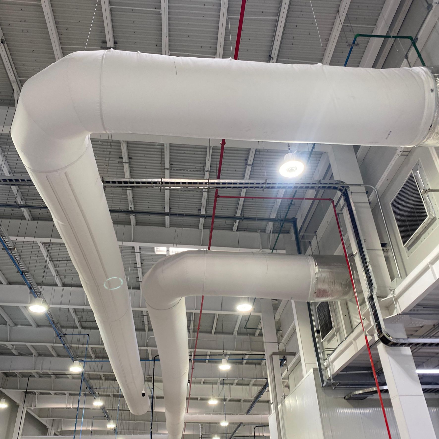White fabric ducts elevate the indoor air quality inside the JUMEX juice plant in Monterrey, Mexico