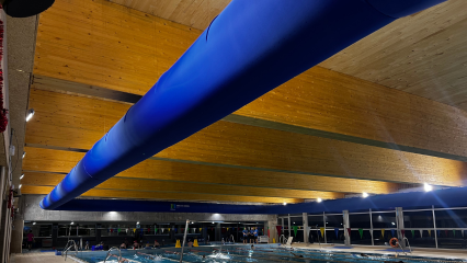 Large blue fabric duct system ensures comfort and high-quality indoor air for an indoor swimming pool in Madrid