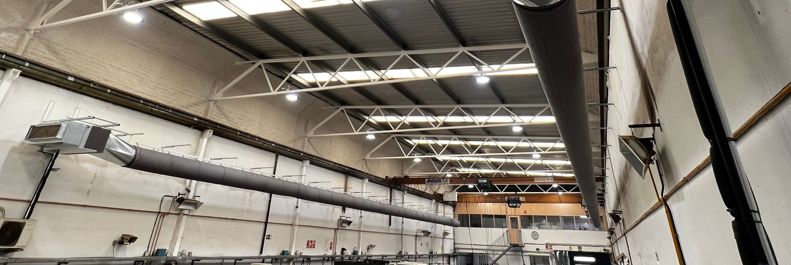 Dark gray fabric air distribution ductwork installed in the MOLMASA manufacturing facility in Barcelona