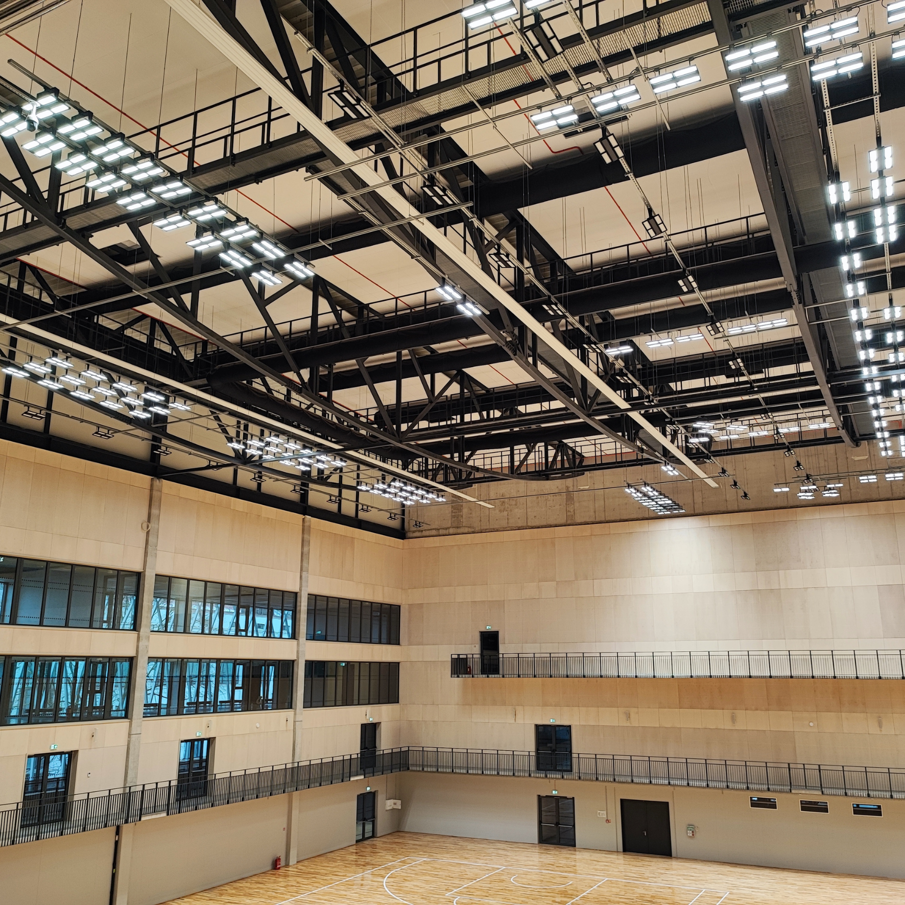 Sleek black fabric duct system improves indoor air quality in the National Sport Centre of Latvia