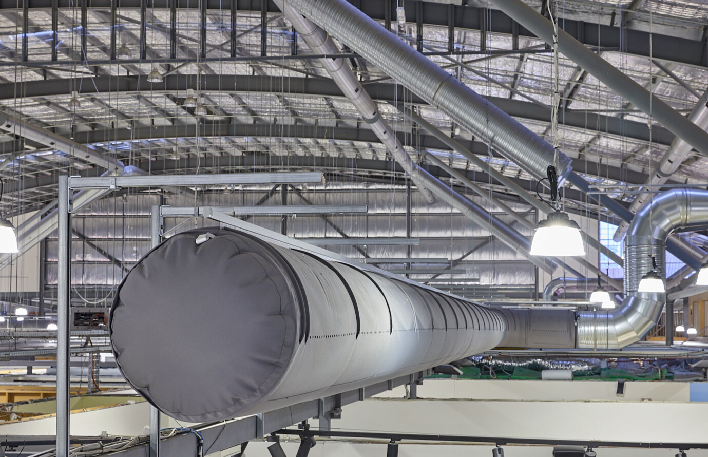 Gray fabric ducting installed in the open ceiling of the Spencer Outlet Centre in Melbourne, Australia