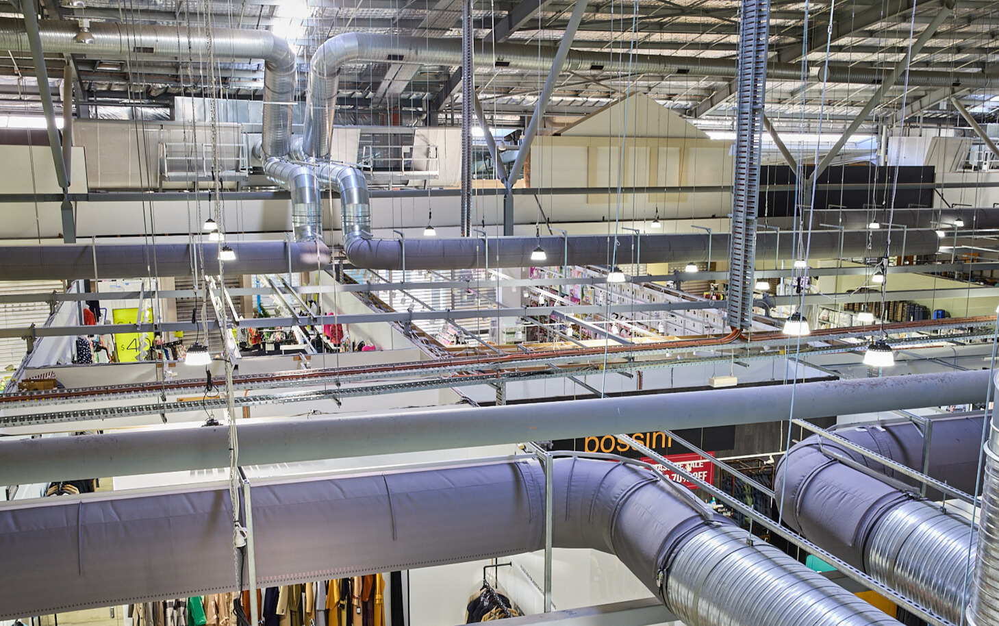 Gray fabric ducting installed in the open ceiling of the Spencer Outlet Centre in Melbourne, Australia