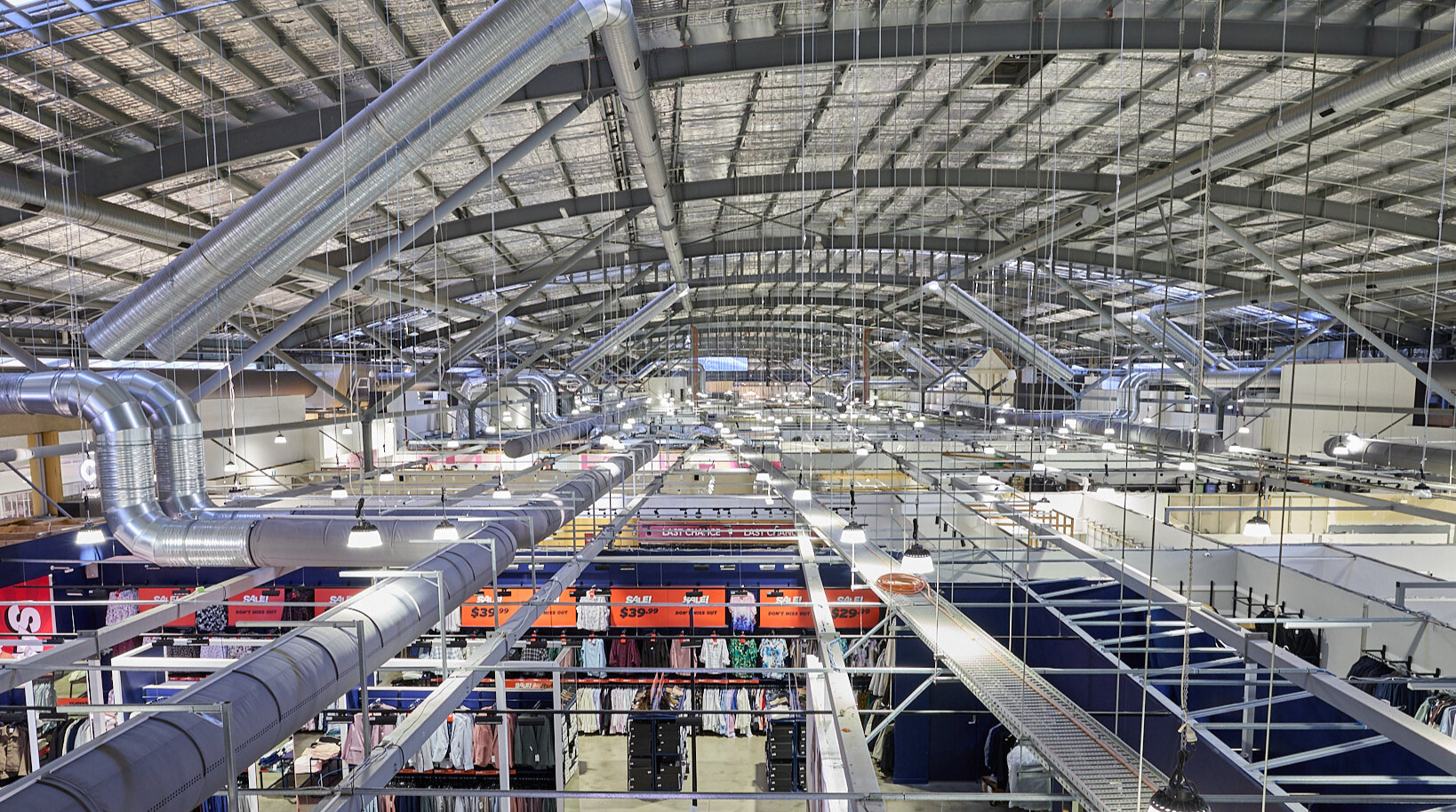 Gray fabric ducting installed in the open ceiling of the Spencer Outlet Centre in Melbourne, Australia