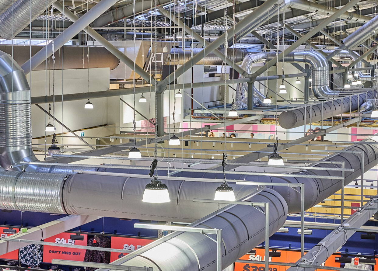Gray fabric ducting installed in the open ceiling of the Spencer Outlet Centre in Melbourne, Australia