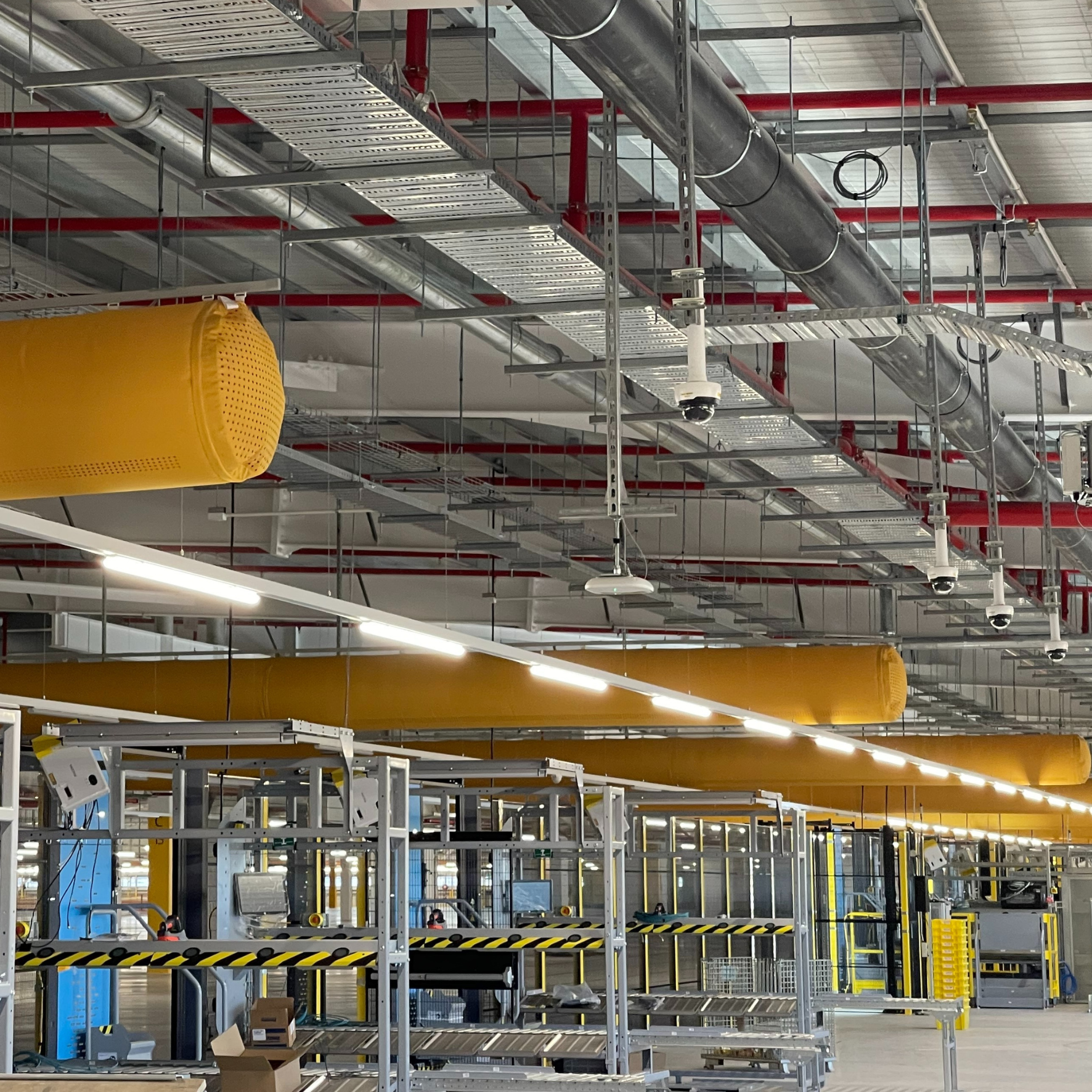 Orange fabric ducts installed in a global distribution center in Australia