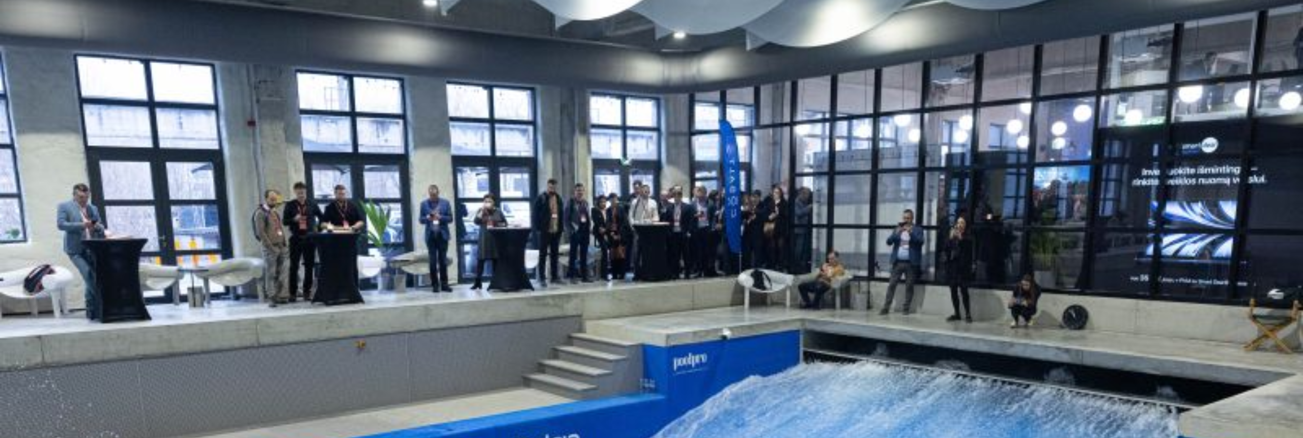 Gray fabric air ducting system provides ventilation for innovative citywave indoor surfing facility in Lithuania