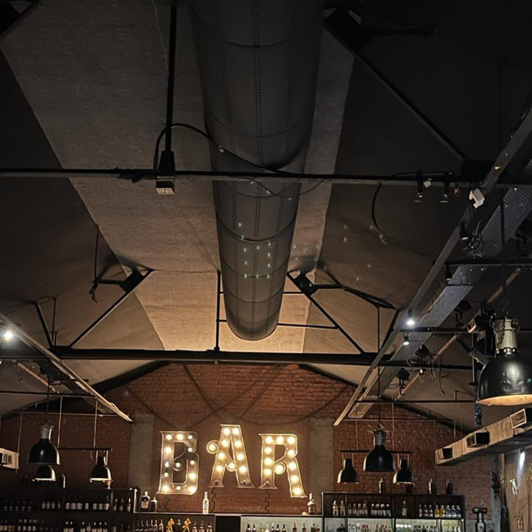 Black fabric ducting provides comfort and enhances the design of a Resto-bar in Thane, India