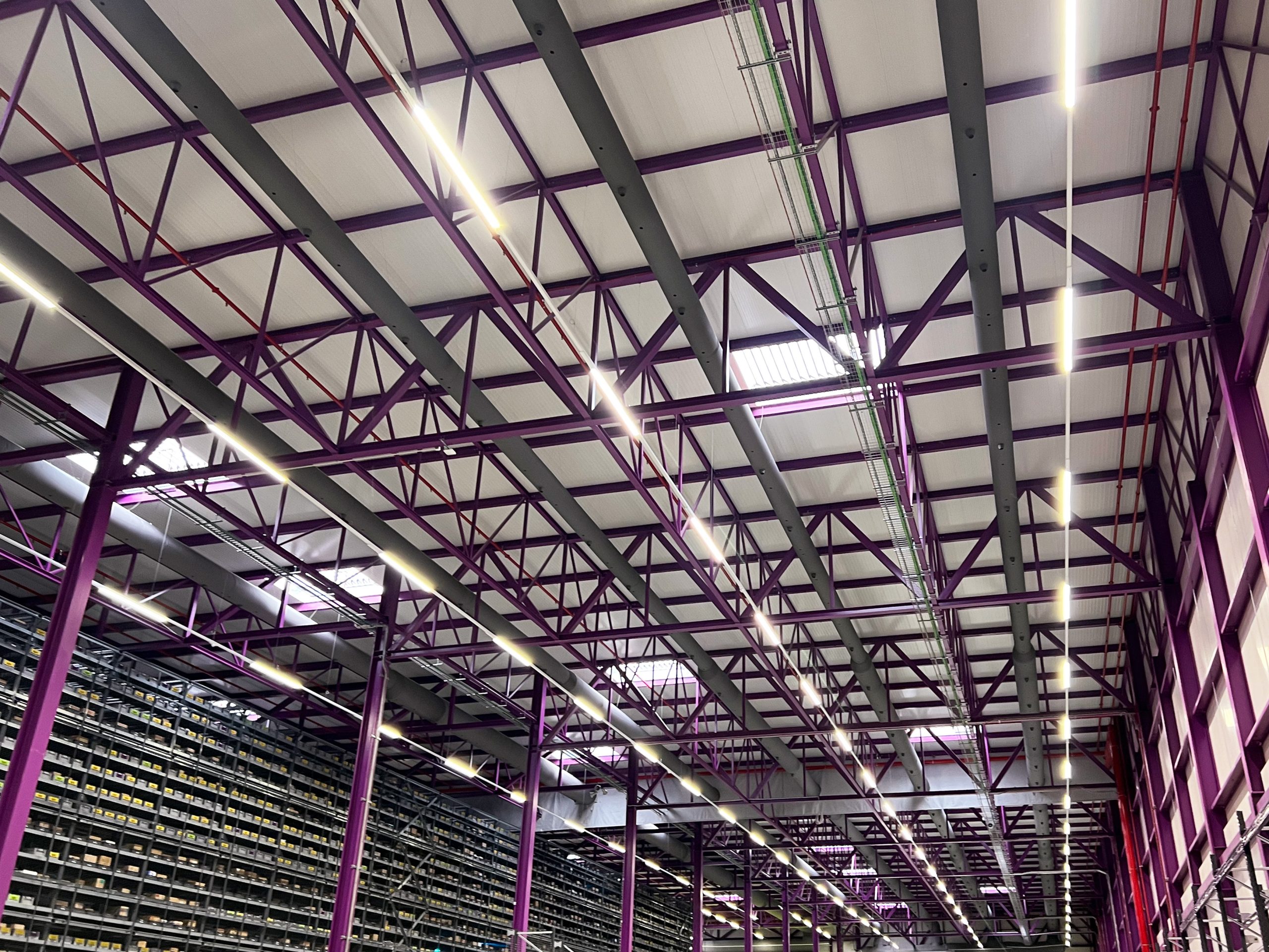 Fabric ducting installed in high ceilings with beams and windows