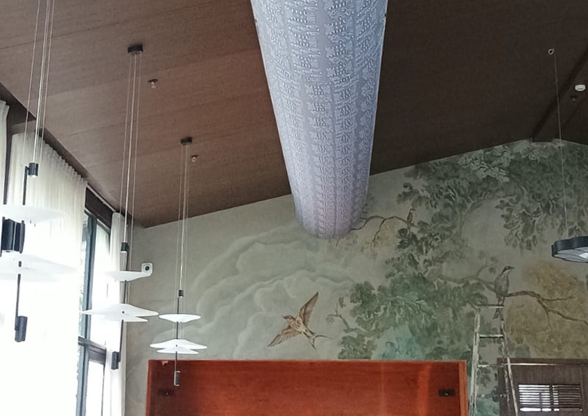 Half round D shape profile fabric duct system by FabricAir installed in 3 meter high ceiling in a restaurant