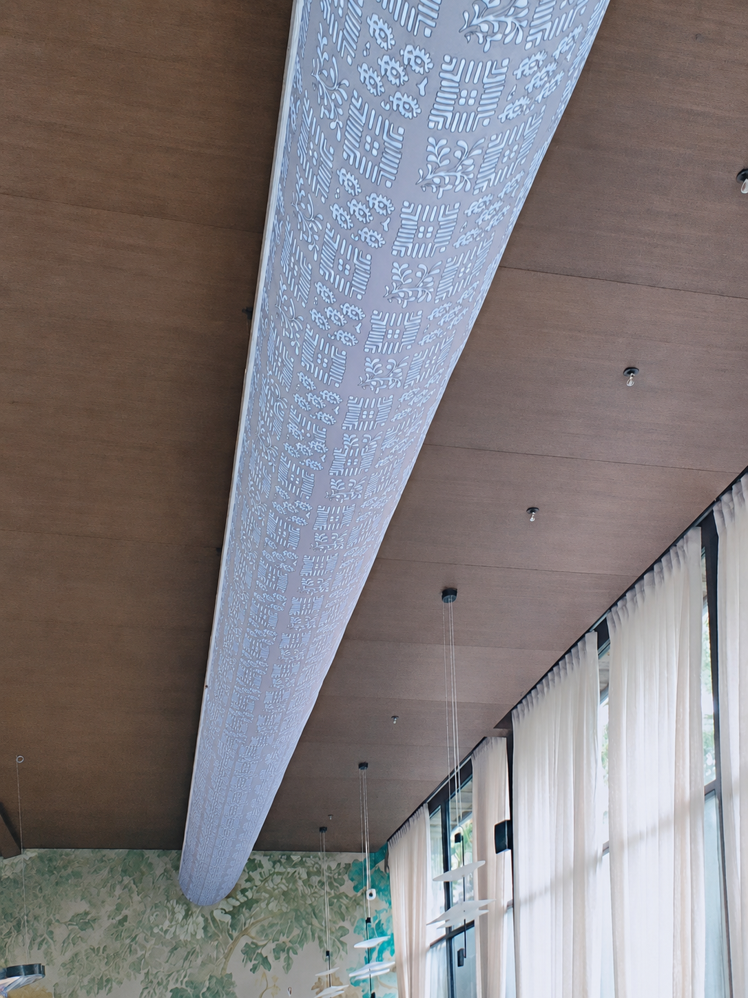 Aesthetic installation of a printed fabric duct system by FabricAir in a slanted ceiling