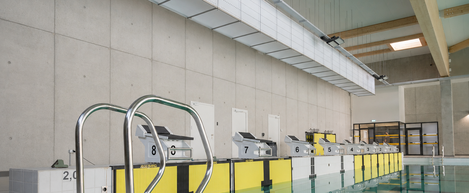 FabricAir's Return Air System is shown aesthetically installed in a pool. A taut rectangular structure complete with a perforated fabric draws contaminated air from the space complementing the supply system for perfect air distribution.