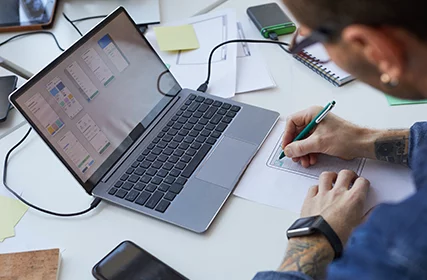 Man working on a laptop inside an office