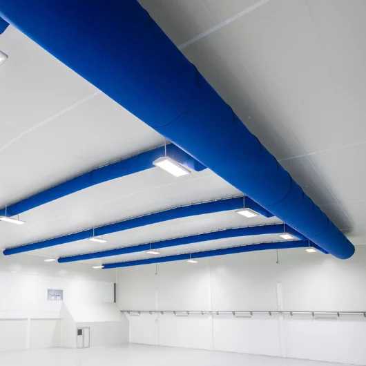 FabricAir ducts in bright blue in a manufacturing facility